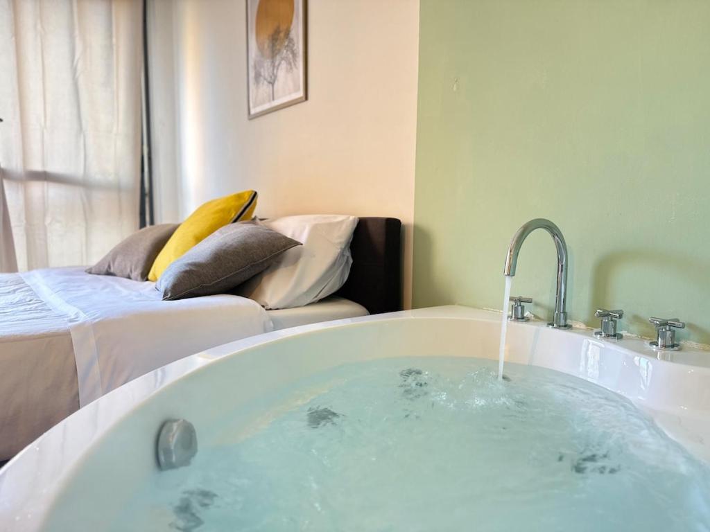 a bath tub with a water fountain in a room at Luxury Studio con Private Jacuzzi, Spa Experience in Perugia