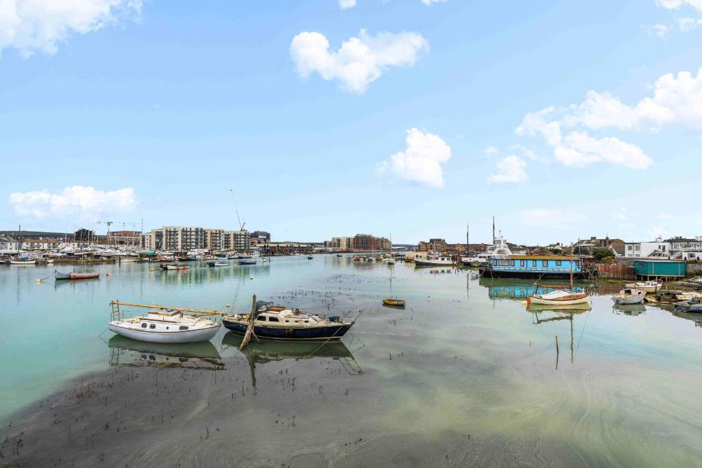 a group of boats are docked in a harbor at Ferry Fab Pad By My Getaways in Brighton & Hove