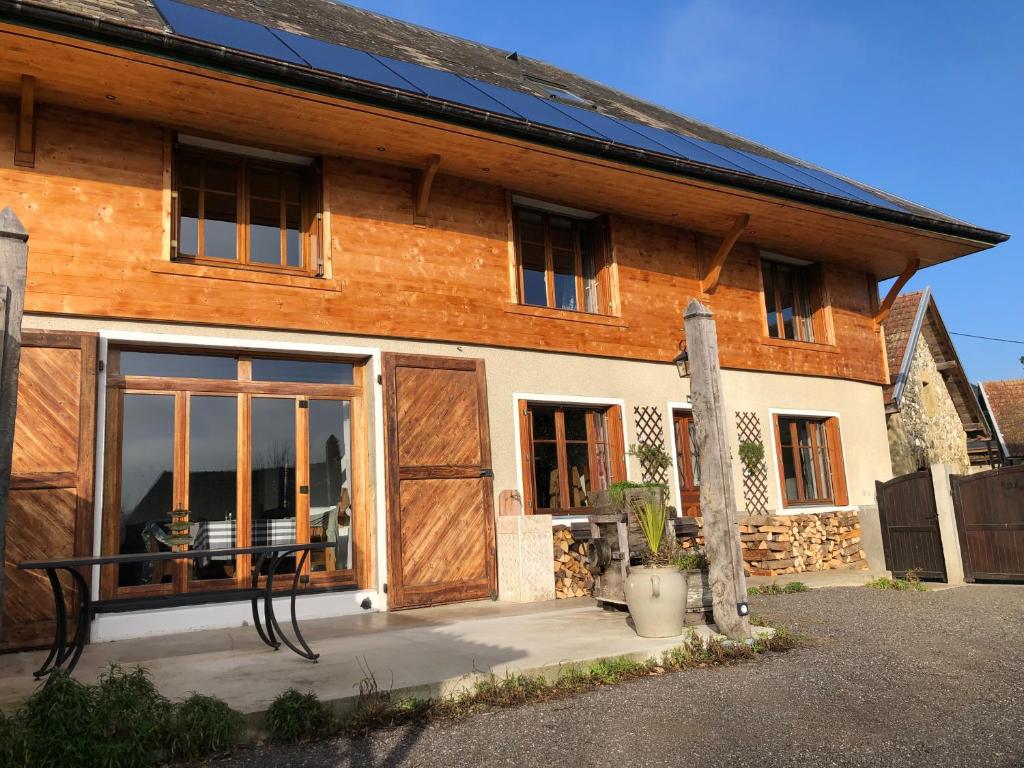 a house with solar panels on the side of it at Gîte Les sources proche Annecy in Vaulx