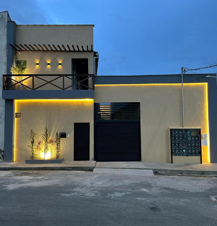 a house with lights on the side of it at Apt 18 - VR Village in São Luís