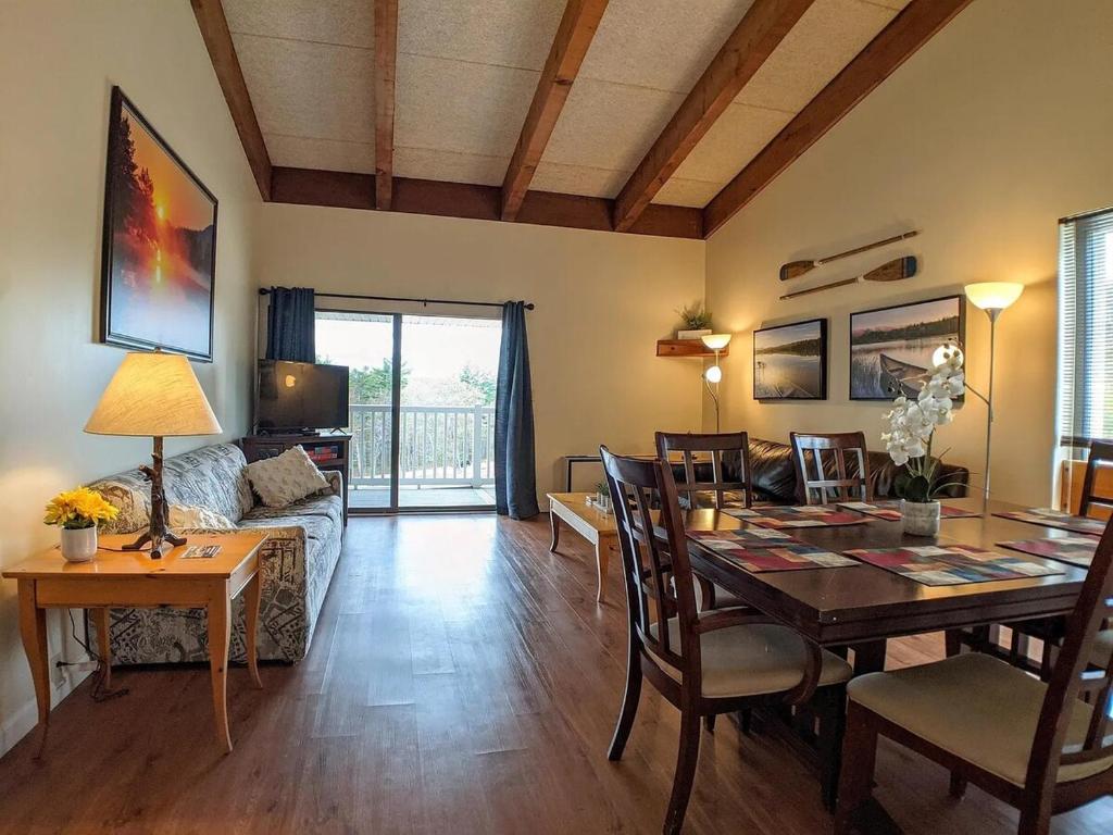 a living room with a table and a dining room at Spacious 2 bd 2 bth Condo at Cedar Lodge Laconia in Laconia