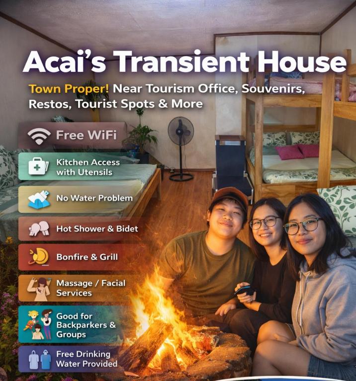 a group of people sitting next to a fire at Acai's Transient House in Sagada