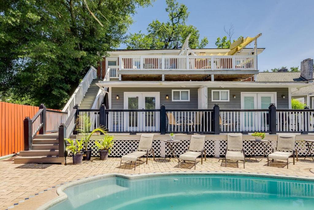 a house with a swimming pool in front of a house at Charming Historic Condo with Pool in Savannah