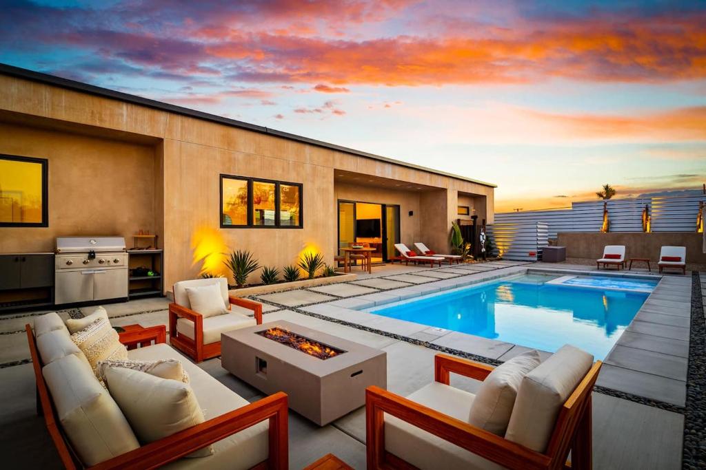 a house with a swimming pool and a living room at Luxury Desert Villa with Pool and Spa in Yucca Valley