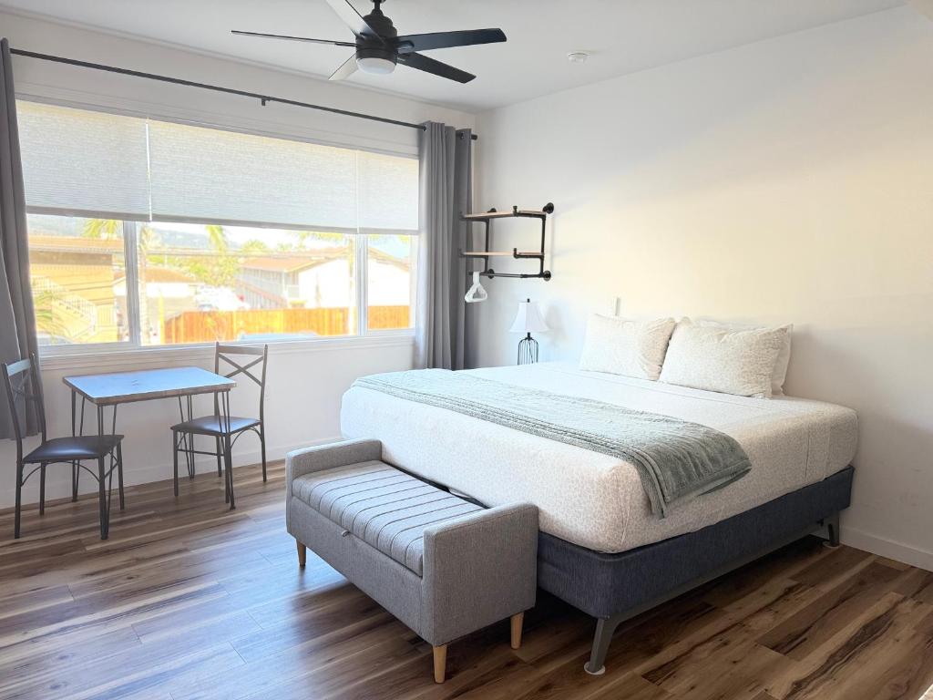a bedroom with a bed and a table and a window at Unit 3 Waena Inn Newly Renovated Maui Private Suite in Wailuku