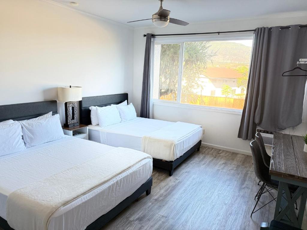 a hotel room with two beds and a window at Unit 10 Waena Inn - Maui Private Suite in Wailuku