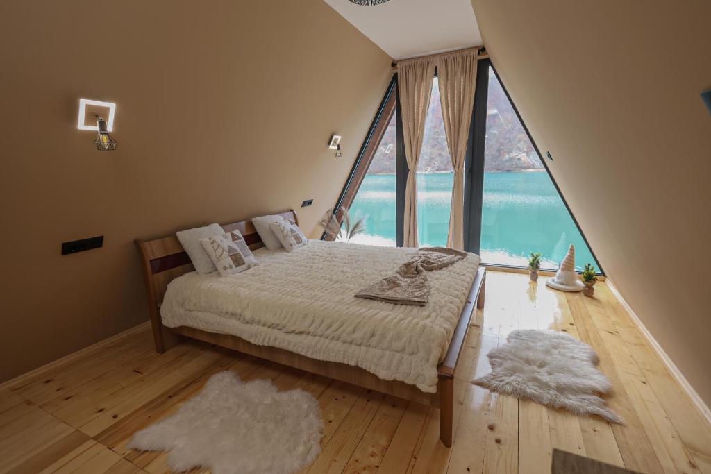 a bedroom with a bed with a large window at "Vista Frame" JAZ - lake view in Višegrad