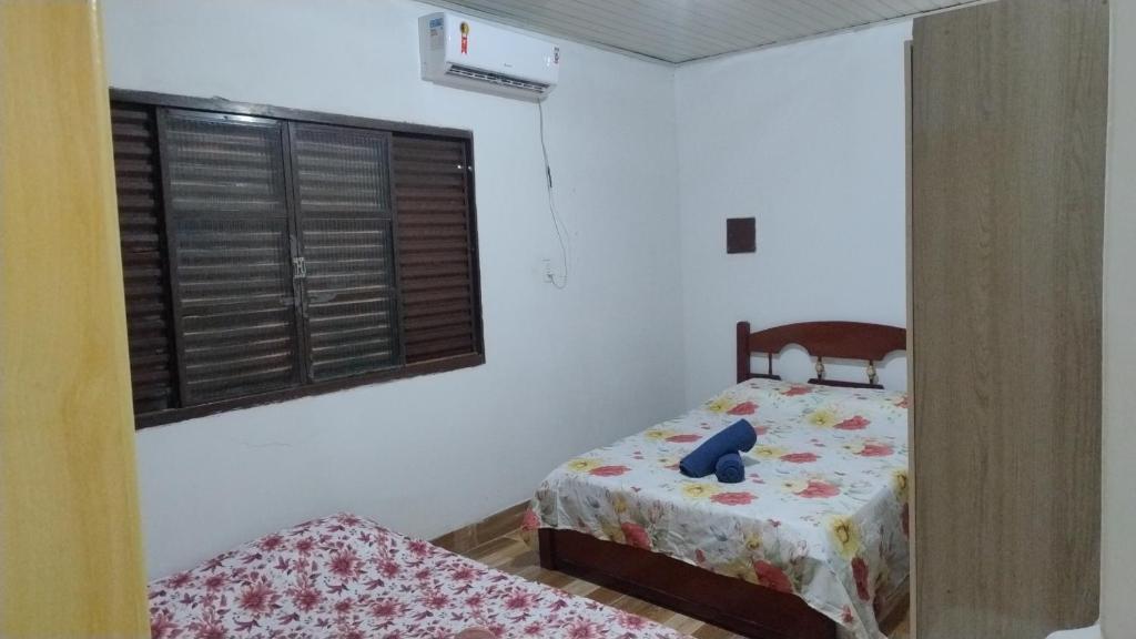 a small bedroom with a bed and a window at Pousada da bancários in São Gabriel