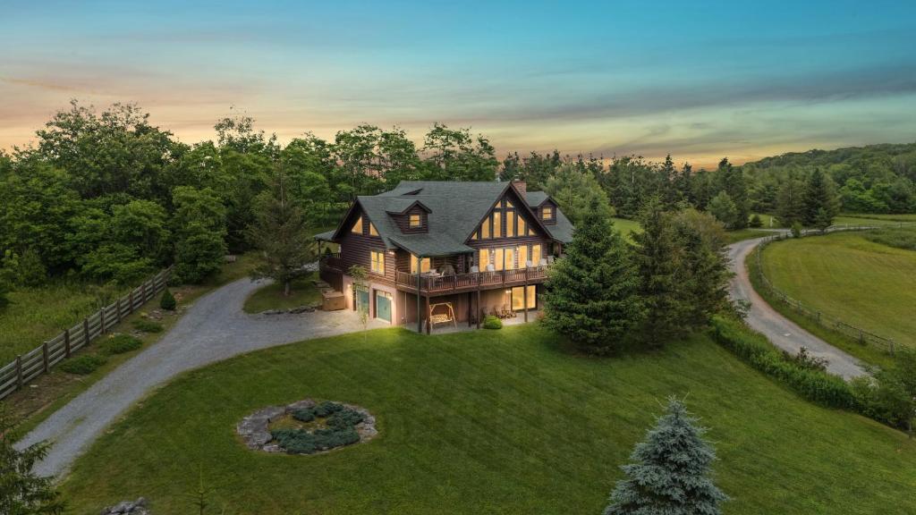 an aerial view of a house on a green field at Alpine Ridge in Banner Elk
