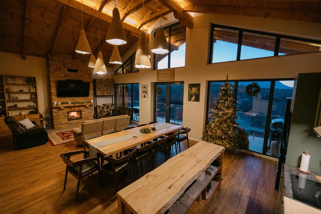 a living room with a table and a christmas tree at Chalet Village Bran in Bran