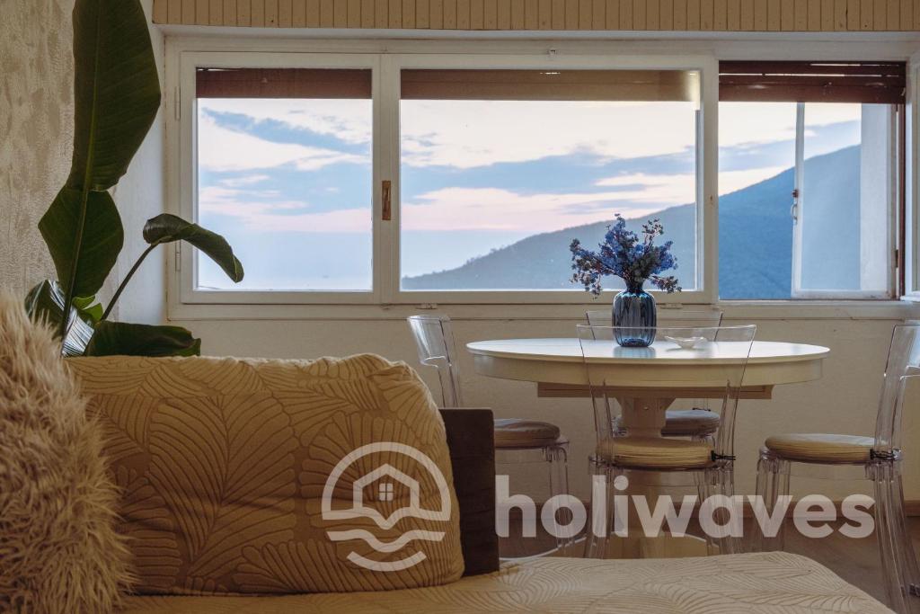 a living room with a table and a window at La casa di Luisa in Moneglia