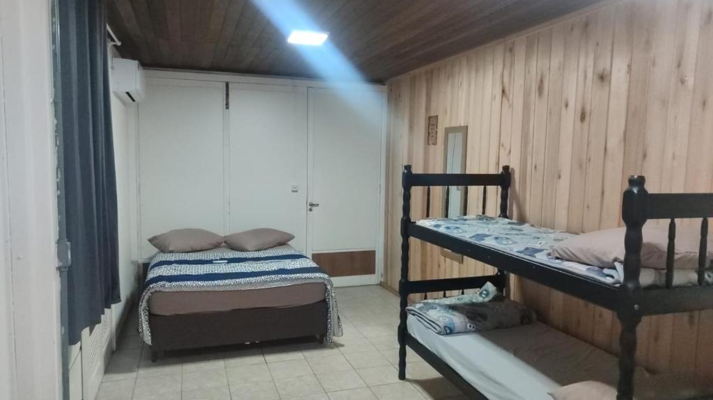 a room with two bunk beds and a window at Pousada Central Quarto 6 in Joinville