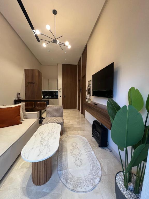 a living room with a couch and a tv at A Suites in Casablanca