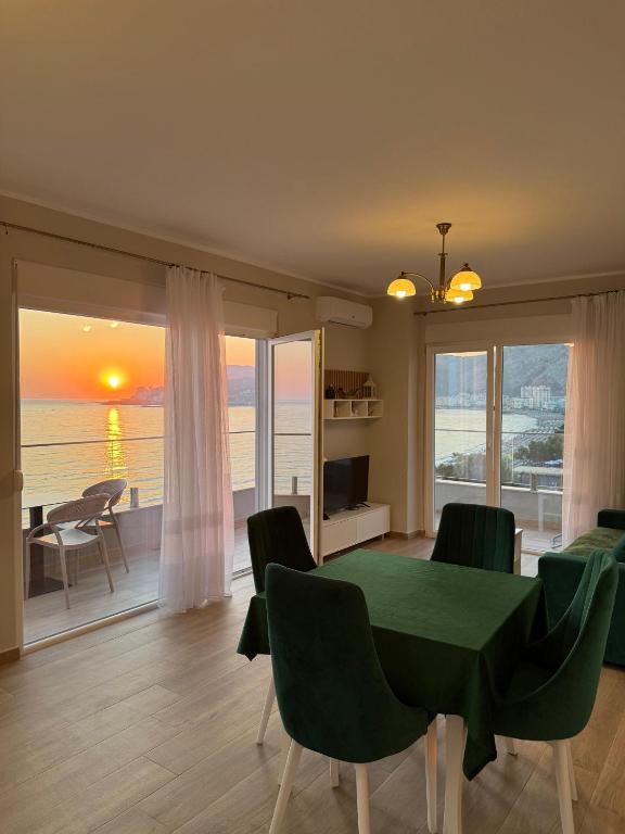 a dining room with a table and a view of the ocean at Sea La Vie in Shëngjin