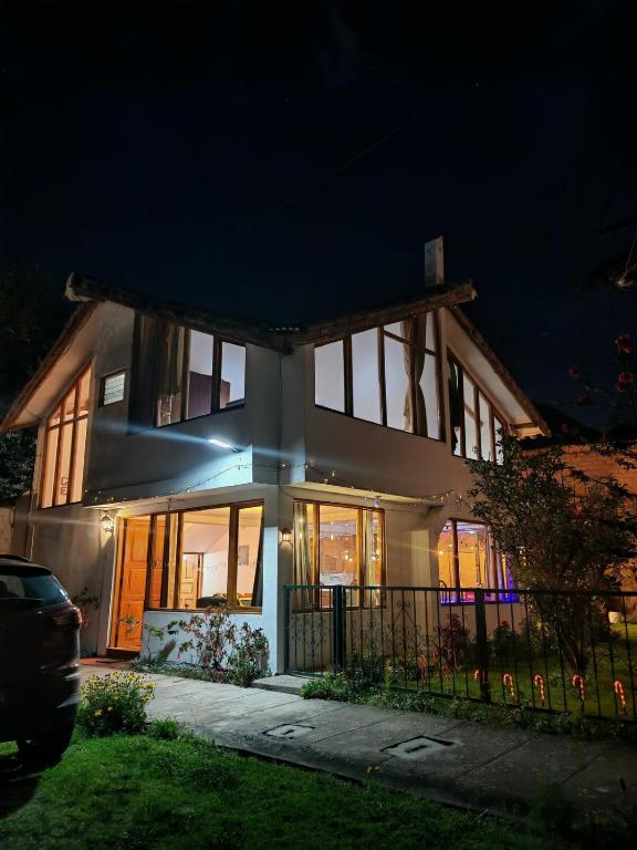 a large house at night with its lights on at UMAY lodge house in Urubamba