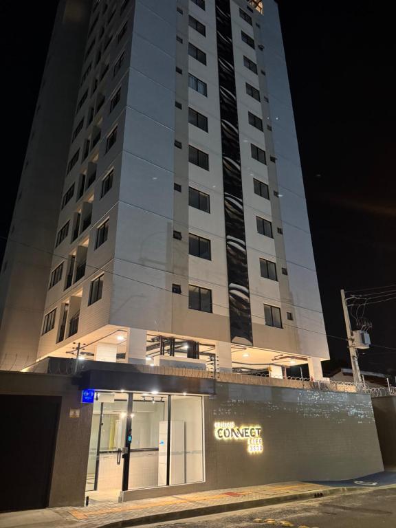 a tall building with a store in front of it at Studio Connect Life in Teresina