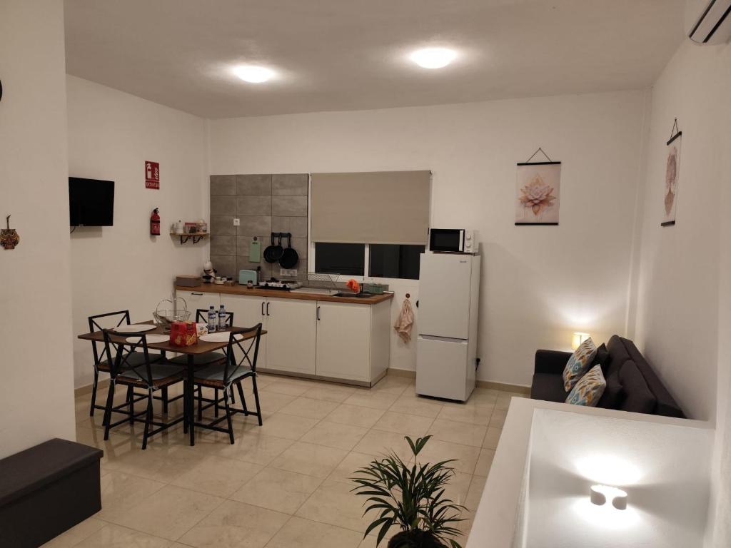 a kitchen and living room with a table and a refrigerator at Vivienda LorenNani in El Paso