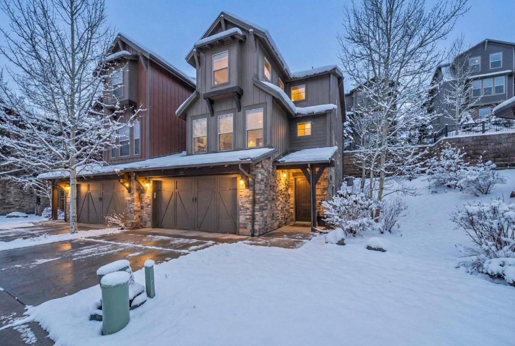 a house with a garage in the snow at Charming 3BR-Near Skiing & Hiking in Kamas