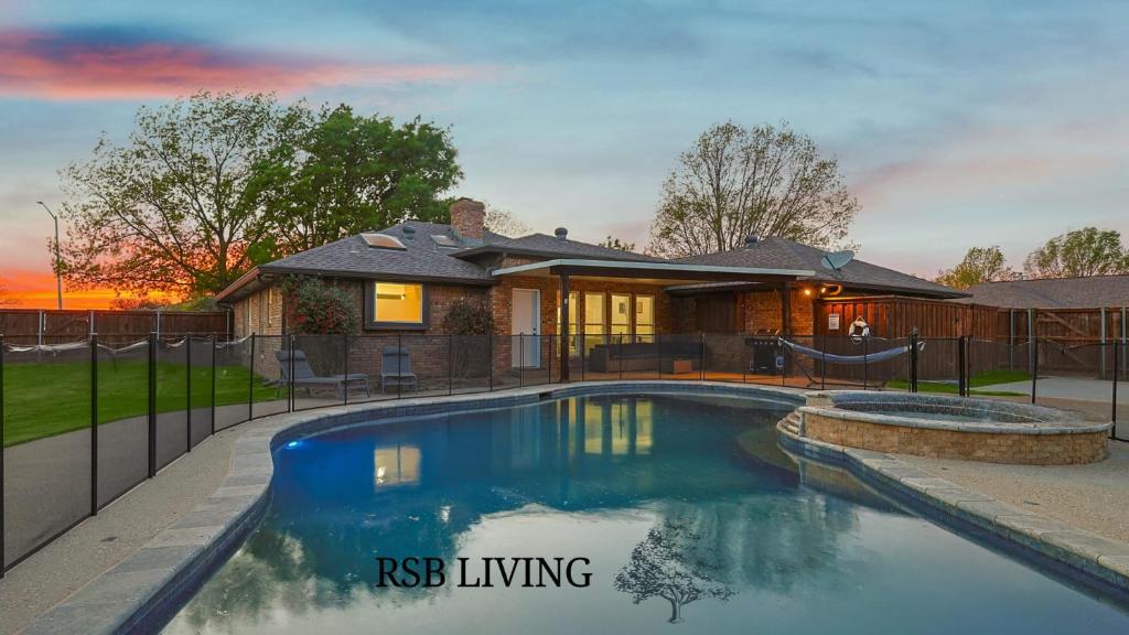a house with a swimming pool in front of a house at Gorgeous 4BR Home with Huge Yard Pool in Denton