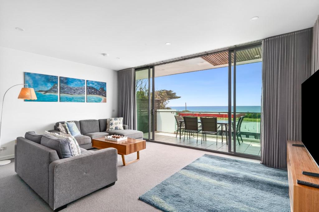 a living room with a view of the ocean at The Dolphin Apartments in Apollo Bay