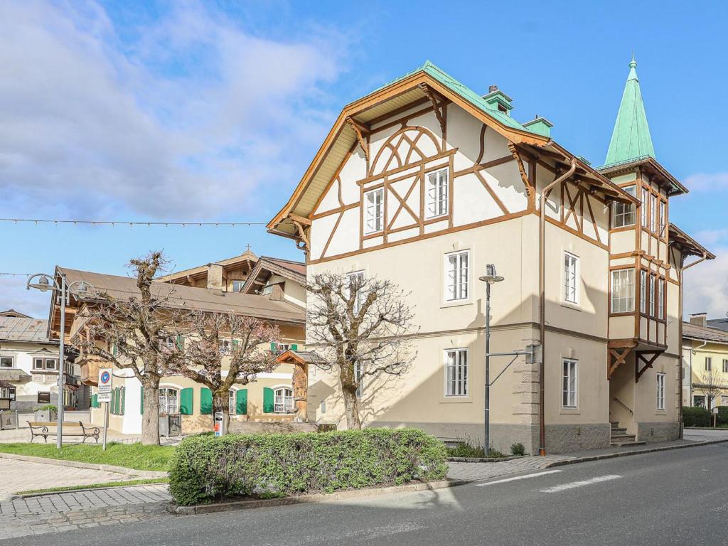a large white building with a steeple on a street at Villa Filzer in Kirchberg in Tirol