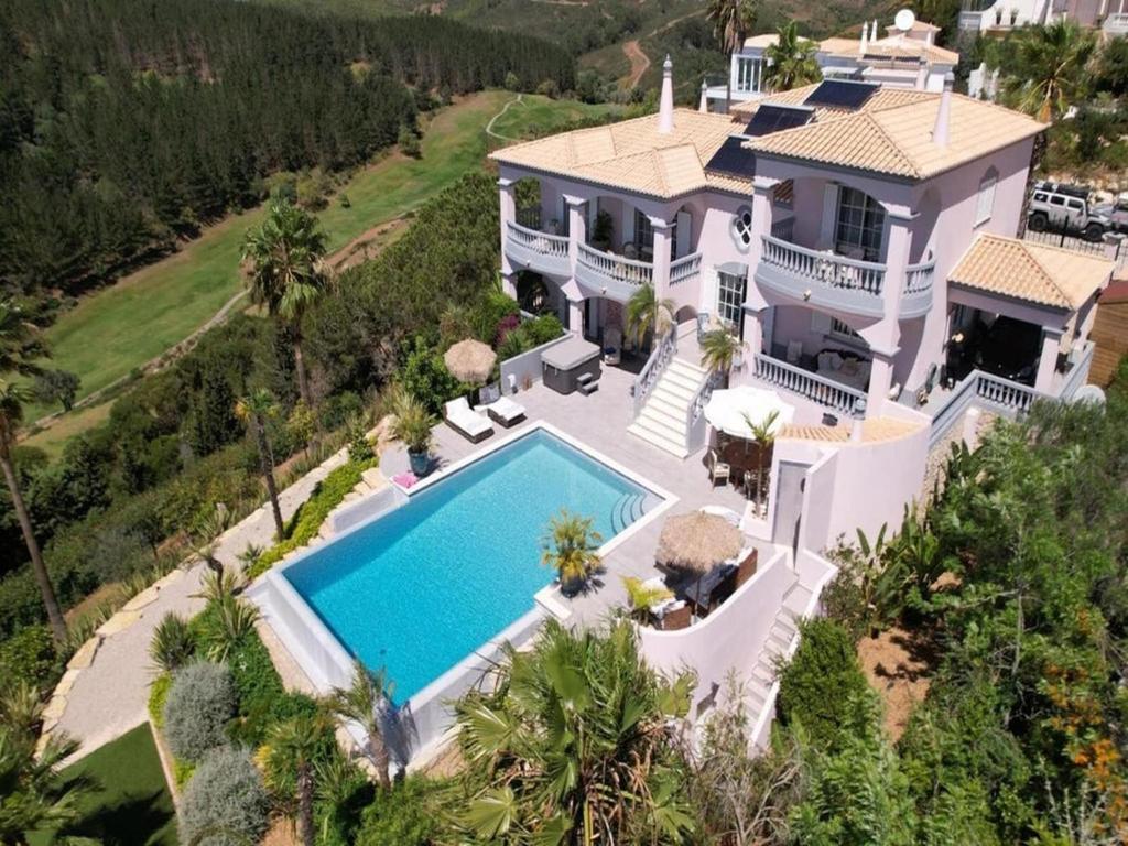 an aerial view of a house with a swimming pool at Private Bedroom in a Luxurious Villa, Budens in Budens