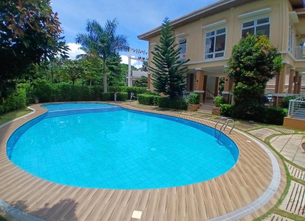 a large swimming pool in front of a house at Camella Verdant - Dolcevita Residence in Puerto Princesa City