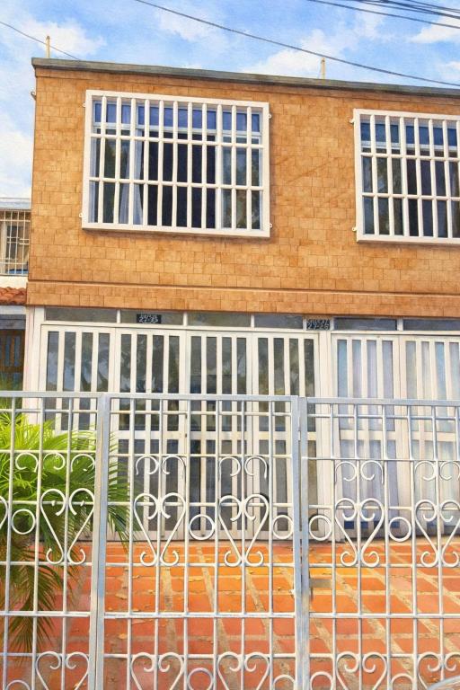a house with a gate in front of it at Oxford House Hostel in Floridablanca