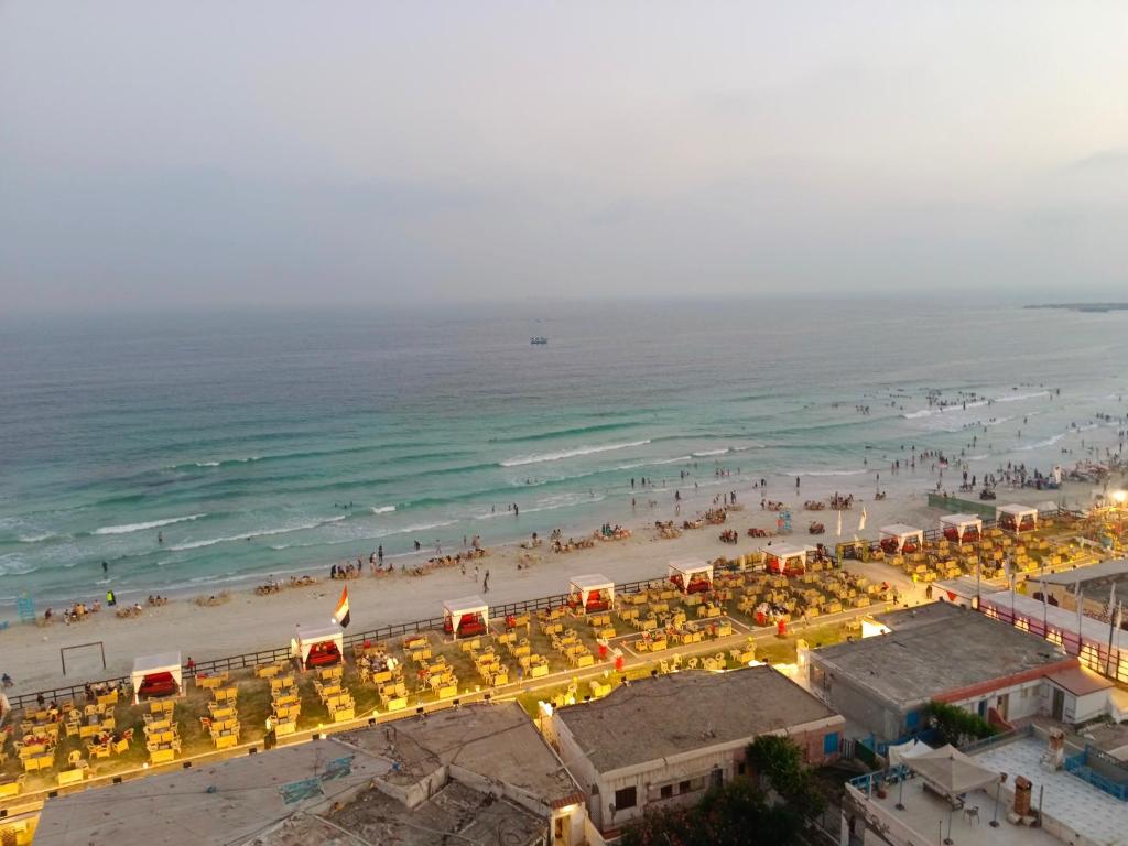 a beach with a lot of umbrellas and the ocean at Charming blue see view apartment in Alexandria