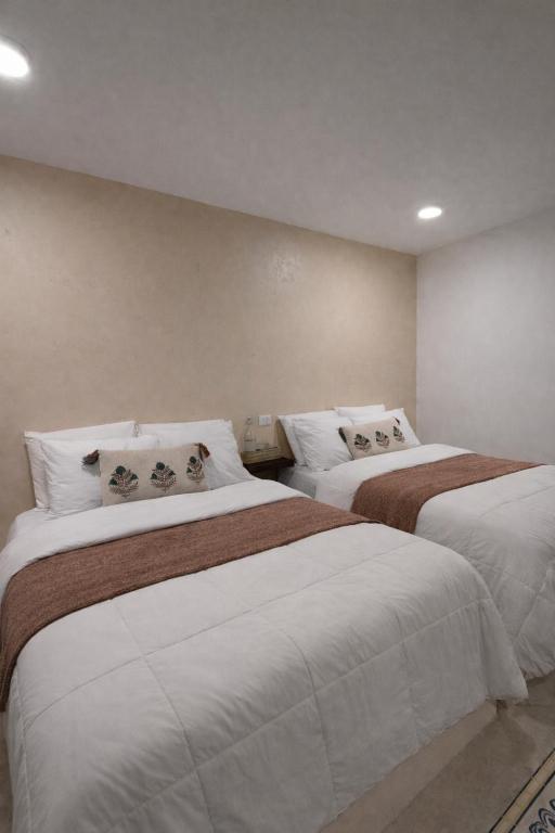 a hotel room with two beds in a room at Chulel Hotel Origen in Cedro