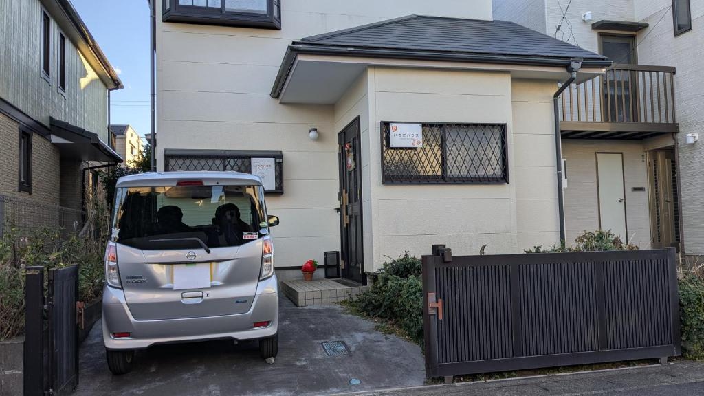 a small car parked in front of a house at いちごハウス in Zushi