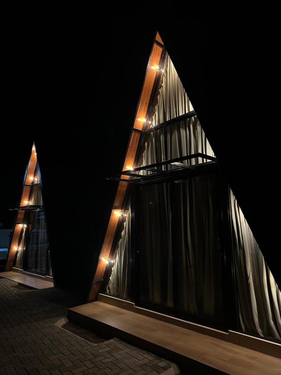 a building with lights on the side of it at night at Âmbar Chalés in Ametista do Sul