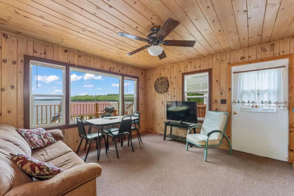 a living room with a couch and a ceiling fan at TB6 Thunder Bay Resort Cabin 6 in Phelps
