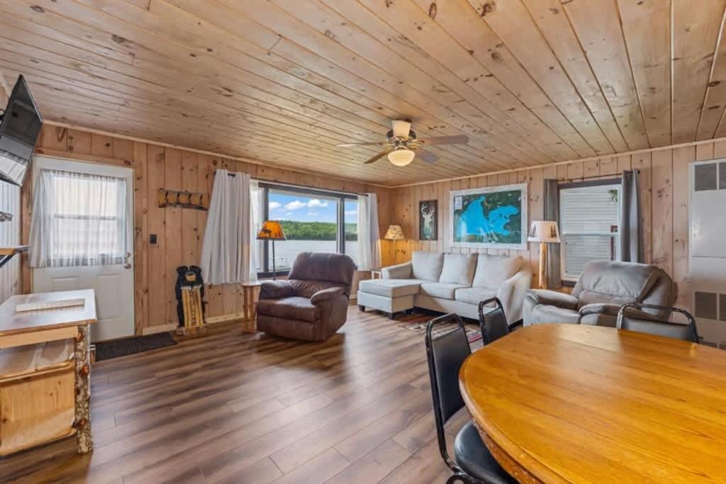 a living room with a wooden ceiling at TB3 Thunder Bay Resort Cabin 3 in Phelps