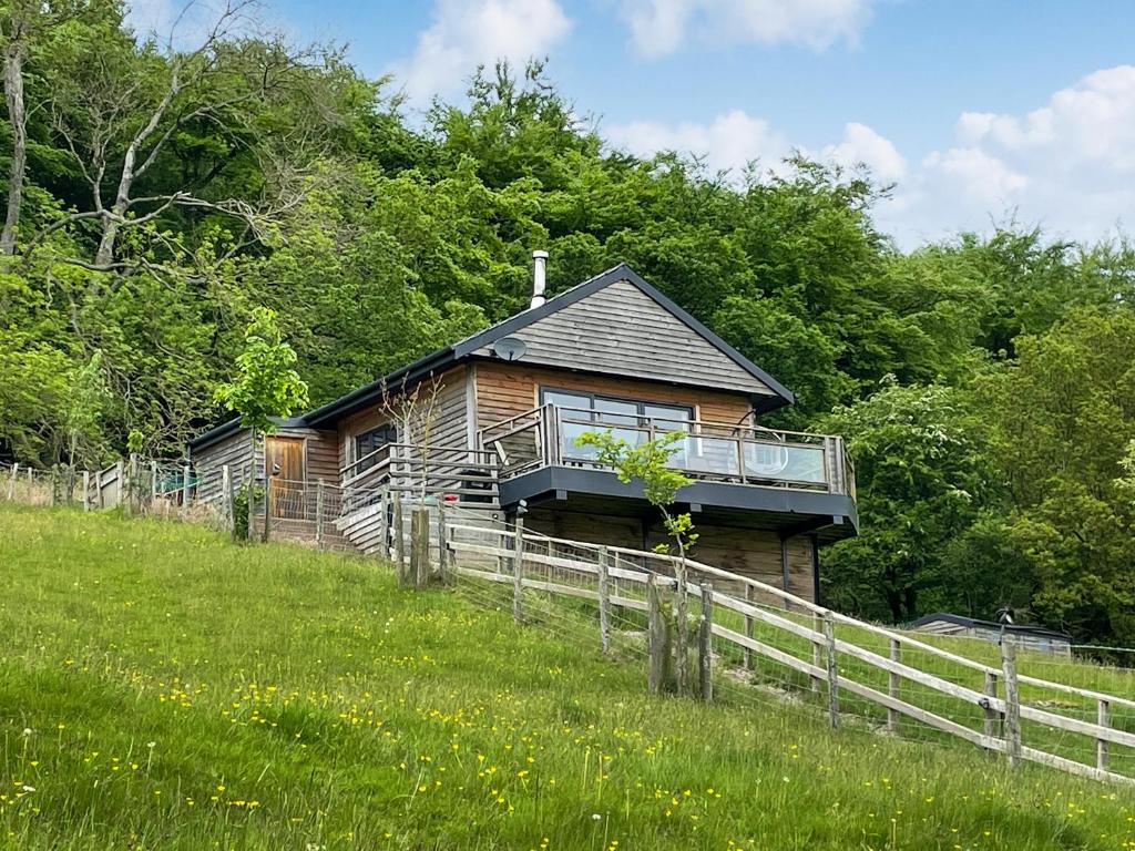 a small house on a hill in a field at Offa's Dyke Lodge - Uk10835 in Old Radnor