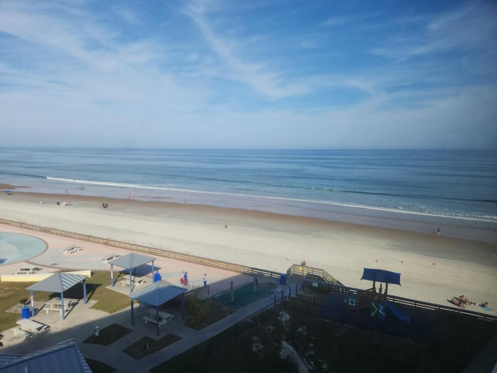a view of a beach and the ocean at Cuddle's Comfort & OCEAN in Daytona Beach