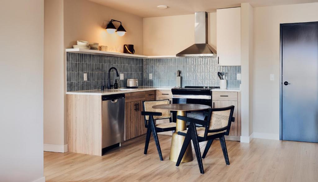 a kitchen with a table and chairs and a sink at The Dylin in Madison