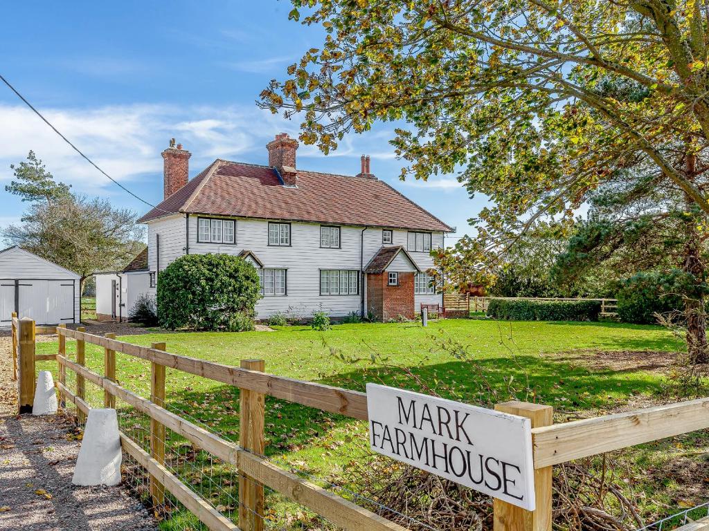 a sign on a fence in front of a house at Mark Farmhouse in Bradwell on Sea