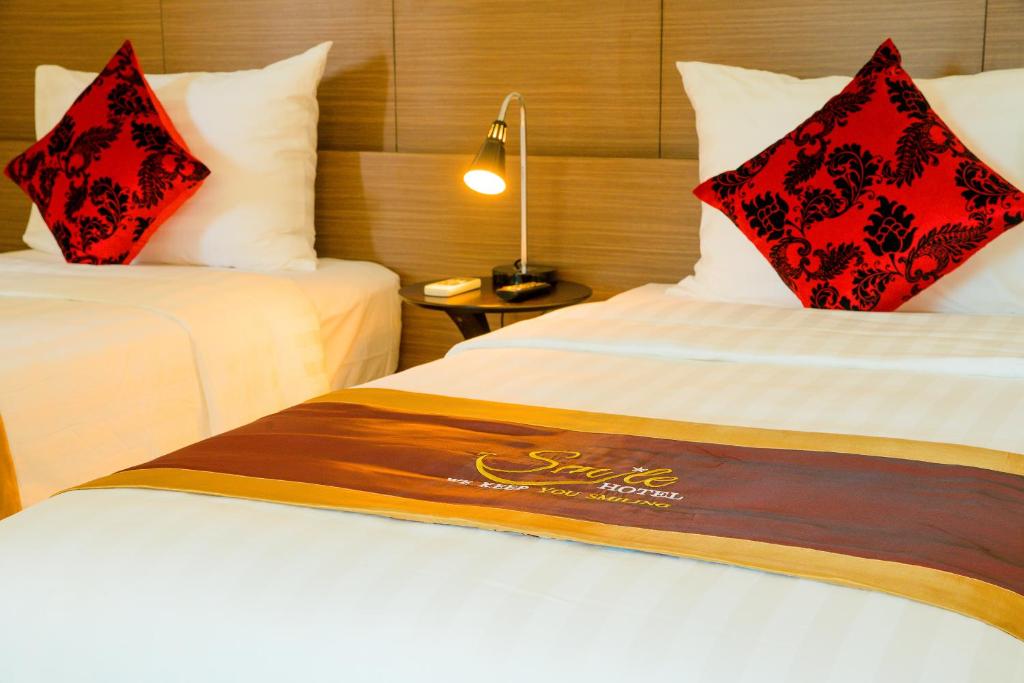 Postel nebo postele na pokoji v ubytování Smile Hotel