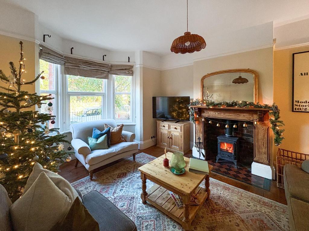 a living room with a christmas tree and a fireplace at The Front House in Great Malvern