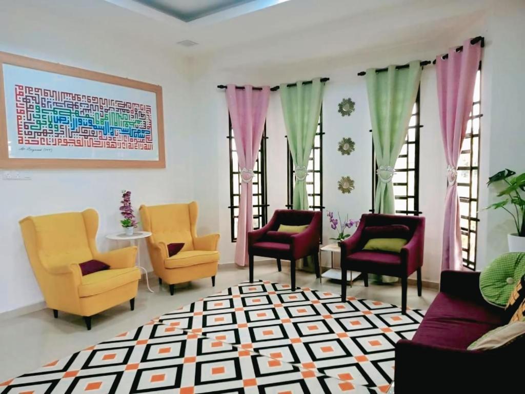 a waiting room with chairs and tables and windows at Sweethome MAMA in Kuala Terengganu