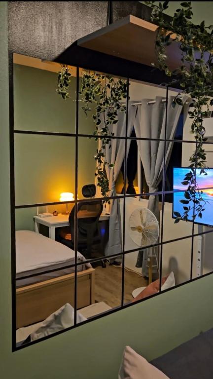 a room with a bed and a desk with a computer at Your Cozy Space in Stanford Suites 3 Brgy Inchican Silang Cavite in Silang