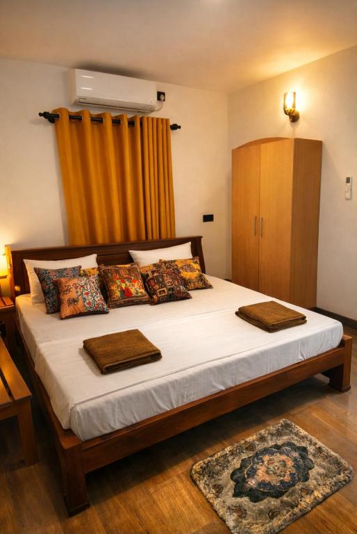 a bedroom with a bed with white sheets and pillows at Hiri Dudes Villa in Dickwella