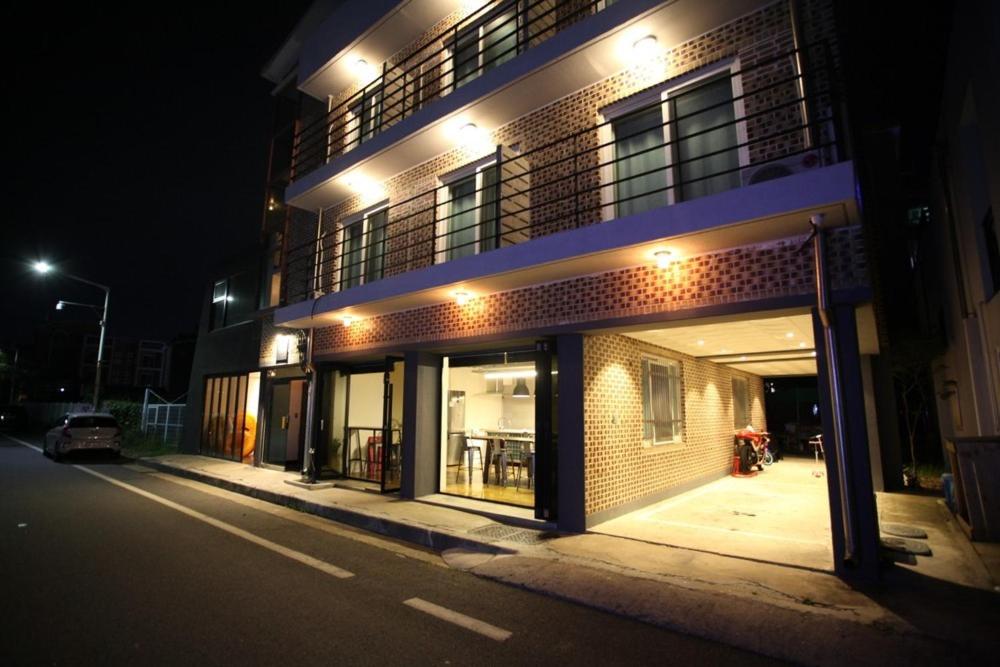 a building with lights on the side of a street at Yangyang Widaehan Guest in Yangyang