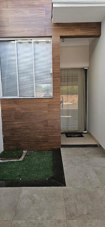 an empty house with a window and a yard at Loft proximo a orla 02 in Presidente Epitácio