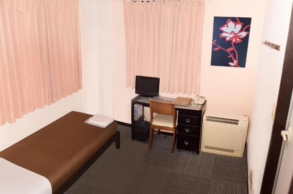 Postel nebo postele na pokoji v ubytování Sakura Hotel Oami