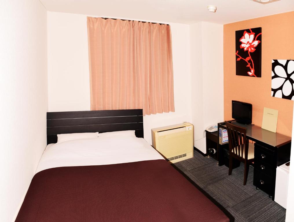 Postel nebo postele na pokoji v ubytování Sakura Hotel Oami