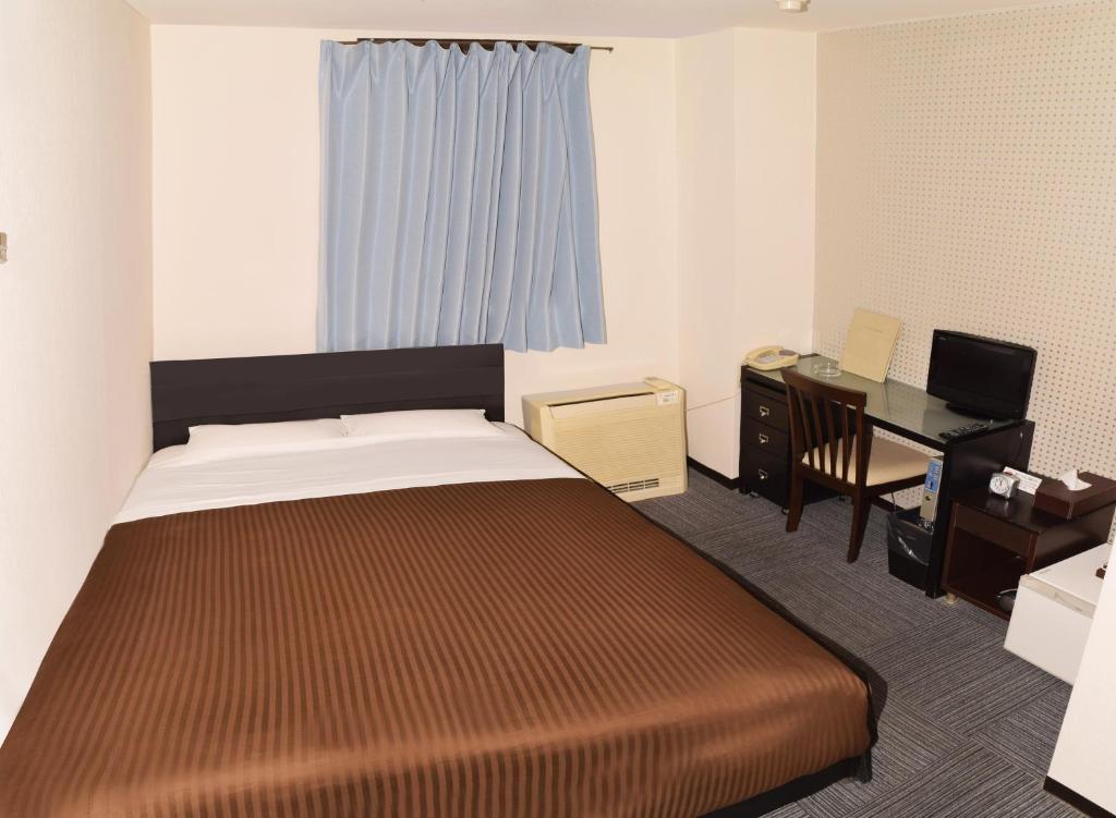 Postel nebo postele na pokoji v ubytování Sakura Hotel Oami