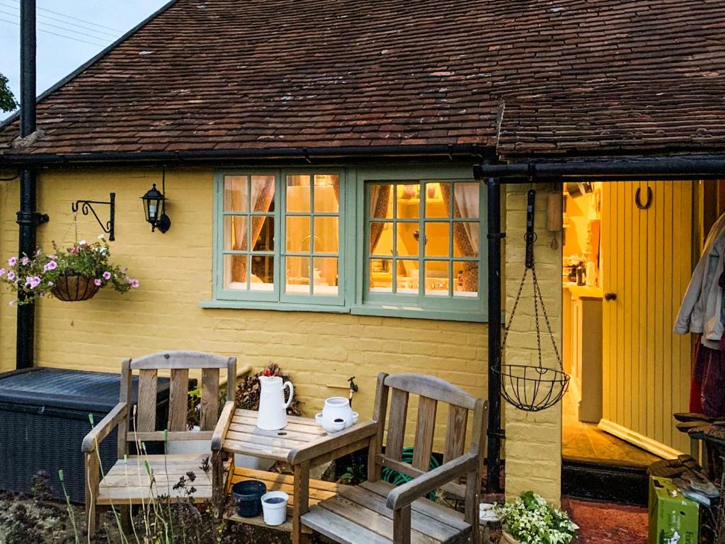 a small house with a table and two chairs at Hill House in Colchester