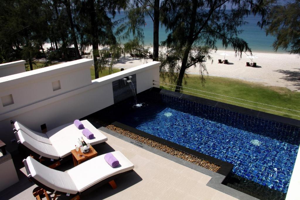 a house with a swimming pool and a beach at Dusit Thani Laguna Phuket in Bang Tao Beach